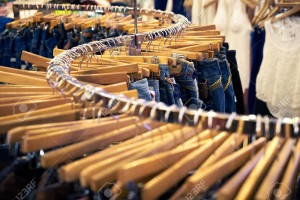 Clothing and retail store: view of clothes shop with jeans hanged on stand